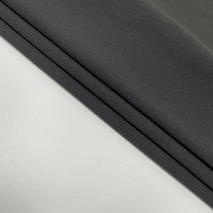 Detail of high-density dark grey knit fabric with soft texture for slim-fit dresses