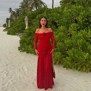 Detail view of the red off-shoulder dress featuring 3D rose ornaments and ruffle texture