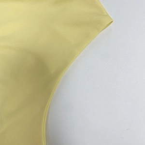Detail of yellow ribbed knit fabric showing high elasticity and fine twill texture