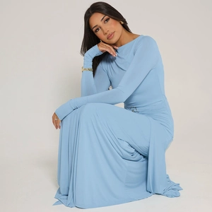 Détail d'une robe moulante bleu clair à manches longues montrant la texture et le drapé