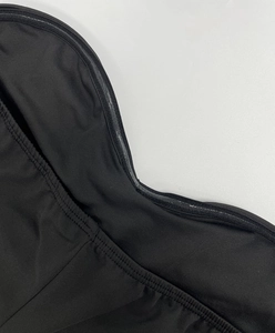 Detail showing non-slip silicone strip on the black sleeveless dress neckline for support