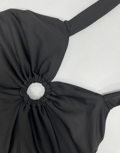 Detail of front ring connector and pleated design on black halter bodycon dress