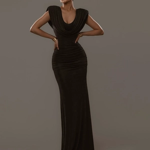 Close-up of elegant cowl neck and pleated waist on a black slim fit velvet evening dress