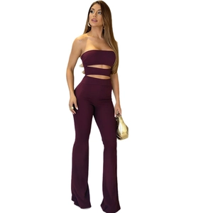 Slim fit burgundy two-piece set featuring cutout top and high waist flared trousers