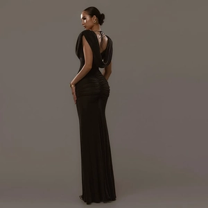 Detail showing the elegant backless design and ruching on this slim fit black evening gown