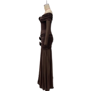 Detail view of coffee-colored off-shoulder dress with side rose and ruching