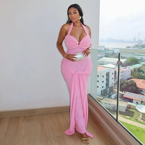 Detail of pink halter neck bodycon dress featuring elegant pleated crossover chest design