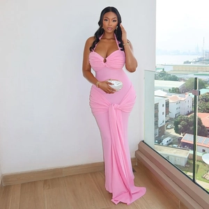 Detail view of pink halter dress with elegant waist knot and draped pleated skirt