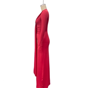 Détails d'une robe longue rouge moulante avec drapé latéral unique et taille plissée