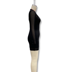 Detail of black bodycon dress featuring sheer mesh long sleeves and red trim on neckline