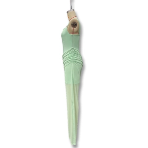 Detail of mint green ruched midi dress with side pleating and mesh texture on mannequin