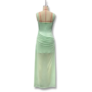 Detail of the mint green ruched dress showing the back zipper and semi-sheer mesh layers