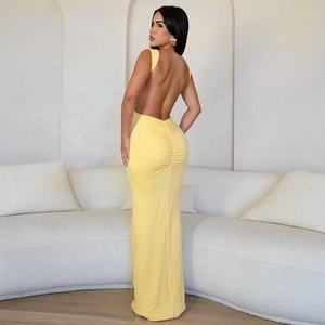 Close-up of backless yellow bodycon dress with elegant ruched texture and slim fit design
