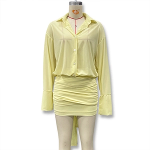 Detail of a bright yellow slim-fit dress with ruched mini skirt and flared sleeves