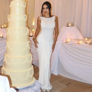 Detailed view of white backless bodycon dress with elegant waist twist and draping design