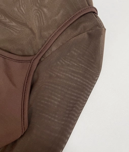 Macro detail of dark brown mesh stitching and premium sewing on this stylish garment