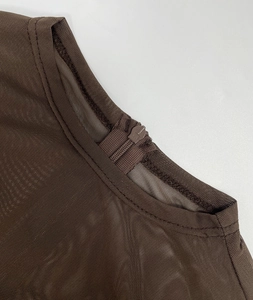 Detail of sheer dark brown mesh top with a smooth invisible zipper at the back neckline
