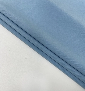 Gros plan sur un tissu en maille côtelée bleu ciel avec texture douce et rayures élastiques