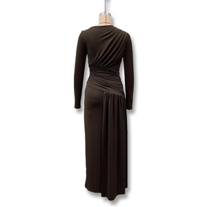Detailed view of handmade asymmetric pleats and ruched texture on dark brown dress