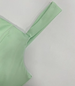Detailed close-up showing stitching on mint green knit strap of slim fit summer dress