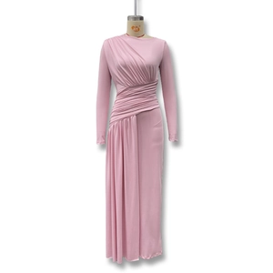 Detail view of pink ruched long sleeve maxi dress showing pleated texture and side draping