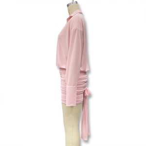 Detailed side view of pink long sleeve ruched dress featuring a lapel collar and waist tie