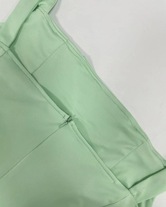 Detail of mint green backless dress showing hidden zipper and premium woven texture