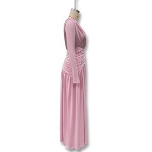 Detail of elegant pink long sleeve maxi dress with stylish pleated side ruffles
