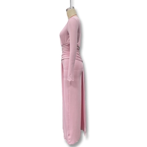 Detailed side view of the elegant pleated waist design on a pink slim-fit maxi dress
