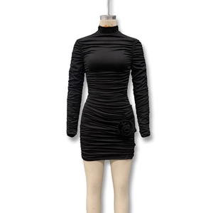 Detailed view of the black ruched mini dress featuring a 3D handmade rose decoration