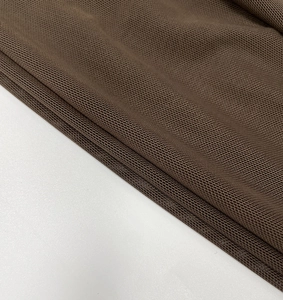 Macro detail of breathable dark brown mesh fabric with a fine and uniform knit structure