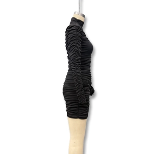 Side view of black long sleeve ruched mini dress featuring a bodycon slim fit silhouette