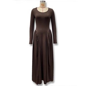 Detailed close-up of dark brown long sleeve dress featuring waist pleats and a flared hem