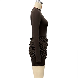 Detail view of the elegant ruched texture and slim fit design on a dark brown mini dress