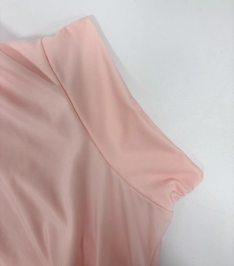 Close-up of pink knit dress detail showing high-elastic ribbed texture and double stitching