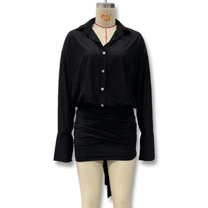 Detail view of the black long sleeve dress featuring ruched skirt and lapel collar design