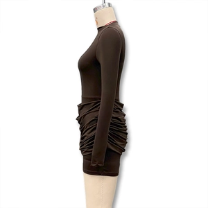 Detail of ruched coffee brown mini dress showing bodycon fit and side pleat textures