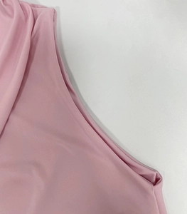 Detailed macro view of the soft pink ribbed fabric texture on this slim fitted dress