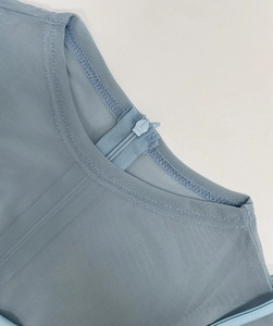 Detail of light blue mesh top showing the round neck and back zipper closure