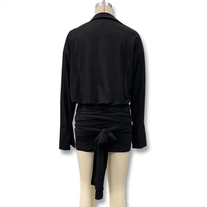 Detail view of black long-sleeved dress with adjustable lacing and gathered bow on back