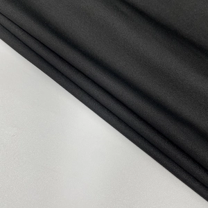 Close-up of black ribbed stretch fabric texture with a subtle silky finish and fine weave
