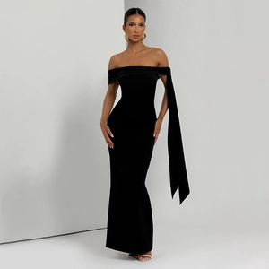 Detail of off-shoulder black slim fit dress with long elegant shoulder streamer detail