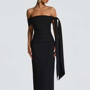 Detail of off-shoulder black slim dress featuring elegant drapes and long ribbon trim