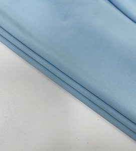 Macro shot of light blue ribbed knit fabric showing soft texture and high flexibility