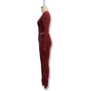 Detail view of deep red dress side cut-out and gathered ruched fabric on the skirt