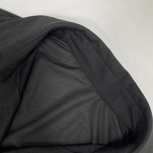 Close-up of black ribbed knit fabric showing detailed stitching and satin lining texture