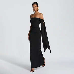 Detail of off-the-shoulder black maxi dress featuring elegant ribbon decoration on the sleeve