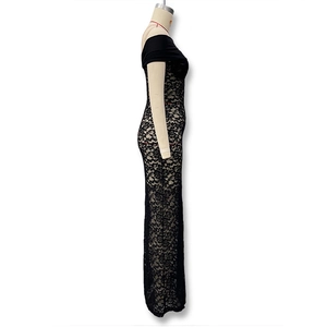 Detail of elegant black sheer floral lace fabric on a slim-fit off-shoulder dress