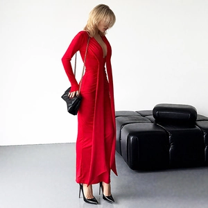 Détail latéral d'une robe longue rouge ajustée avec décolleté en V profond et longs rubans