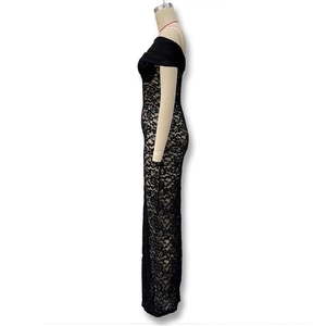 Detail shot of sheer floral lace fabric and side slit on a slim fit black maxi dress